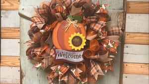 Vibrant Autumn Wreath On A Rustic Door Wallpaper