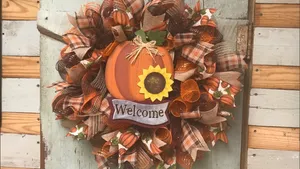 Vibrant Autumn Wreath On A Rustic Door Wallpaper