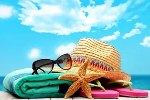 Vibrant Beach Accessories Arranged On Perfect Golden Sand Wallpaper