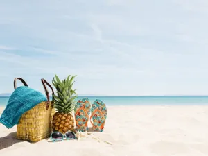 Vibrant Beach Bag Essentials On Sandy Shore Wallpaper