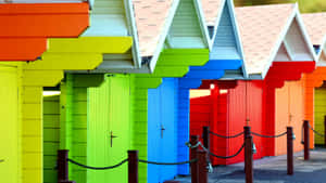 Vibrant Beach Huts By The Seashore Wallpaper