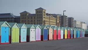 Vibrant Beach Huts Under The Bright Sun Wallpaper