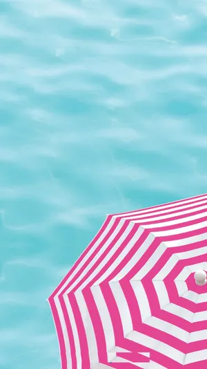Vibrant Beach Umbrella In The Sun Wallpaper