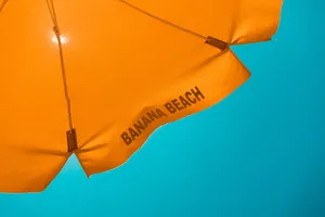 Vibrant Beach Umbrella On A Sunny Day Wallpaper