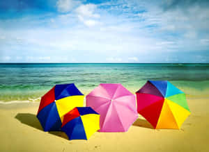 Vibrant Beach Umbrella On Sunny Seashore Wallpaper