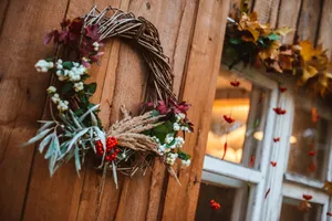 Vibrant Fall Wreath On Rustic Wooden Door Wallpaper