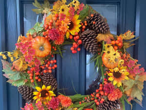 Vibrant Fall Wreath On Rustic Wooden Door Wallpaper