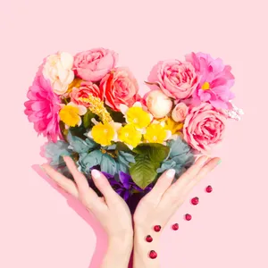 Vibrant_ Floral_ Bouquet_ Hands_ Pink_ Background.jpg Wallpaper