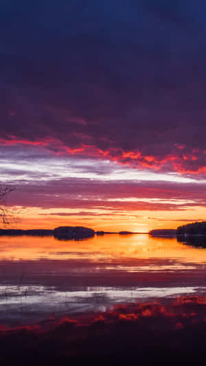 Vibrant Lake Sunset Silhouette Wallpaper