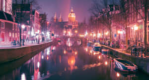 Vibrant Night Scene Of The Iconic Red Light District In Amsterdam Wallpaper