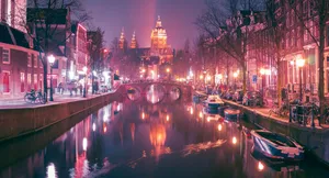 Vibrant Night Scene Of The Iconic Red Light District In Amsterdam Wallpaper
