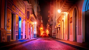 Vibrant Nightlife Cobblestone Street Wallpaper