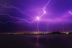 Vibrant Purple Lightning Over City Wallpaper