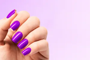 Vibrant Purple Manicureon Hand Wallpaper