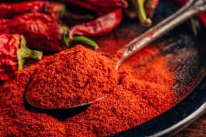 Vibrant Red Chili Powder In A Bowl Wallpaper