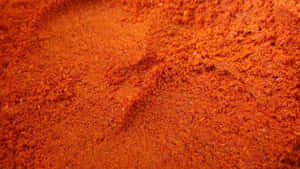 Vibrant Red Chili Powder In A Rustic Bowl Wallpaper