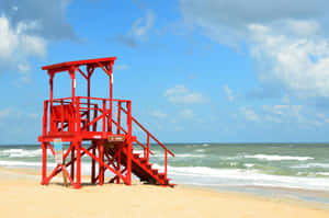 Vibrant Red Lifeguard Tower Beach Wallpaper