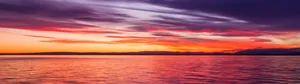 Vibrant Sunset Over Water Panorama Wallpaper