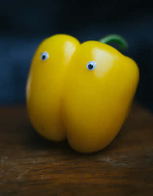 Vibrant Yellow Bell Pepper On A Rustic Background Wallpaper