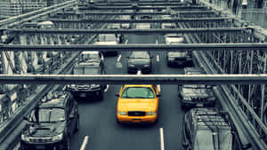 Vibrant Yellow Cab In Urban Cityscape Wallpaper