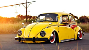 Vibrant Yellow Car Cruising In Style Wallpaper