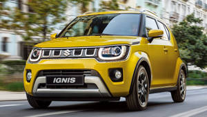 Vibrant Yellow Suzuki Ignis On Road Wallpaper