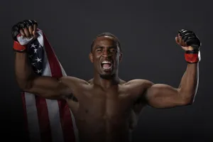 Victorious M M A Fighterwith American Flag Wallpaper