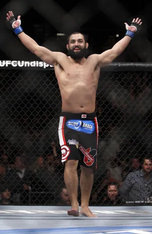 Victorious Moment – Johny Hendricks Celebrating His Win In The Octagon Wallpaper
