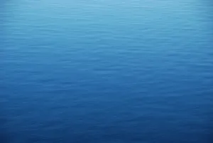 View From Above Of The Calm Blue Ocean Water Wallpaper