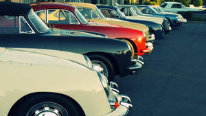 Vintage Beauty Parked: An Old Car In The Lot Wallpaper