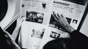 Vintage Black And White Newspaper On A Wooden Table Wallpaper