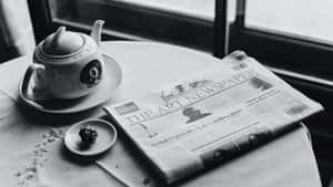 Vintage Black And White Newspaper On A Wooden Table Wallpaper