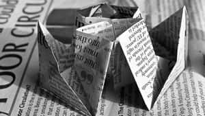 Vintage Black And White Newspaper On A Wooden Table Wallpaper