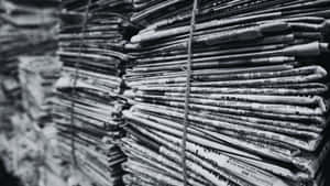 Vintage Black And White Newspaper On A Wooden Table Wallpaper