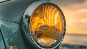 Vintage Car Headlightat Sunset Wallpaper