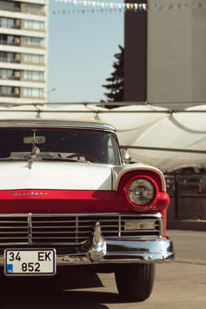 Vintage Car Near Buildings Iphone Wallpaper