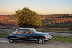 Vintage Citroen D S Countryside Sunset Wallpaper