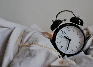 Vintage Clock On Bed Wallpaper