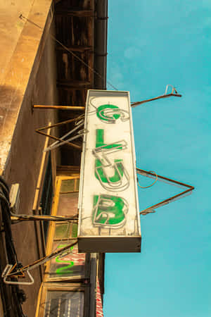 Vintage Club Sign Against Blue Sky Wallpaper