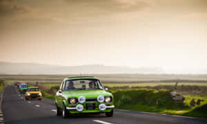 Vintage Ford Escort Cruising Down The Highway Wallpaper