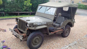 Vintage Jeep Willys Conquering Off-road Terrain Wallpaper