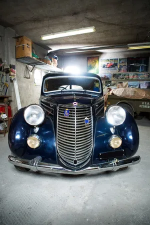 Vintage Lancia Aprilia Garage Scene Wallpaper