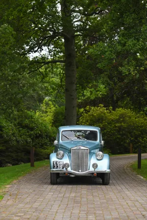 Vintage Lancia Aprilia On Cobblestone Road Wallpaper