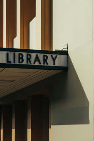 Vintage Library Sign Shadow Play Wallpaper