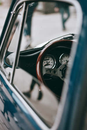 Vintage Mobile Device On A Wooden Table Wallpaper