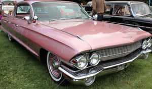 Vintage Pink Cadillac Car In A Stunning Photoshoot Wallpaper