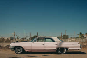 Vintage Pink Cadillac On The Open Road Wallpaper