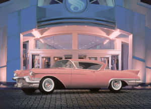 Vintage Pink Cadillac Shining Under The Blue Sky Wallpaper