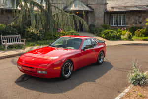 Vintage Porsche 944 Gliding On An Open Road Wallpaper