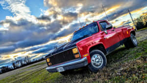 Vintage Red Square Body Truck Under Cloudy Sky Wallpaper